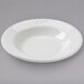 A white Tuxton pasta bowl with an embossed rim.