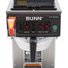 A Bunn automatic coffee brewer with upper and lower warmers and a stainless steel funnel on a counter.