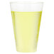 A Fineline clear plastic tumbler filled with yellow liquid on a white surface.