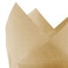 A close-up of a Hoffmaster Unbleached Natural Tulip Baking Cup with a fold on it.