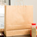 Duro Cargo Natural Kraft Paper Shopping Bag with Handles 18" x 7" x 18 3/4" - 200/Bundle Main Thumbnail 1
