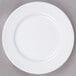 A Tuxton Alaska bright white china plate with a wide rim.