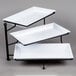 An American Metalcraft three tiered rectangular display stand with black ironwork and white melamine platters.