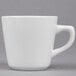 A white porcelain coffee cup with a handle.