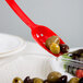 A red Cambro salad bar spoon with olives in it.