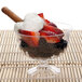 A Fineline Flairware clear plastic dessert cup filled with strawberries, chocolate, and whipped cream.