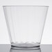 A WNA Comet Classicware clear plastic cup on a white surface.