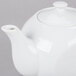 A white CAC porcelain teapot with a lid.