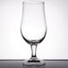 A Libbey stemmed pilsner glass on a table with a white background.