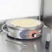A pancake cooking on a Waring round crepe maker.
