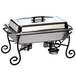 A wrought iron American Metalcraft chafer stand holding a chafing dish.