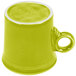 A close-up of a green Fiesta china mug with a white handle.