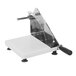 A white and black Tellier manual bread slicer on a white surface.