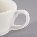 A Libbey ivory porcelain coffee cup with a handle.