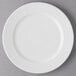 A white Reserve by Libbey porcelain plate with a curved edge.