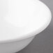 A close-up of a white bowl with a white rim.