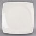 A Libbey ivory porcelain coupe plate with a white rim on a gray surface.