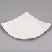 A Libbey ivory porcelain coupe plate with a curved edge.