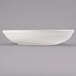 A Libbey ivory porcelain shallow pasta bowl on a gray surface.