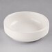 A Libbey Ivory porcelain multi-purpose bowl on a gray background.
