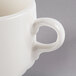 A Libbey ivory porcelain tea cup with a handle.