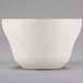 A Libbey St. Francis ivory porcelain bouillon bowl with a small handle on a gray surface.
