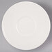 A Libbey ivory porcelain medium saucer with a white circle on a gray surface.