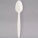 A white cornstarch teaspoon with a handle.