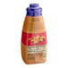 A close-up of a Torani 64 fl. oz. bottle of Sugar-Free Caramel Flavoring Sauce with a blue cap.