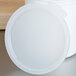 A white plastic Cambro lid on a white crock.
