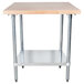 An Advance Tabco wood top work table with a galvanized metal base and undershelf.