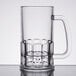 A clear plastic beer mug with a handle.