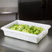 A white Rubbermaid food storage container filled with chopped lettuce.