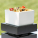 A white square Cal-Mil melamine box with pasta and vegetables inside.