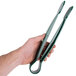 A hand holding a pair of green Thunder Group flat grip tongs.