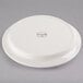 A white Libbey porcelain compartment plate with a circular design on it.