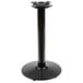 A Lancaster Table & Seating black cast iron table base with a black cylinder column.
