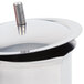 A Thunder Group stainless steel server with a closed handle and a lid.