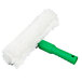 A white fluffy brush with a green plastic handle.