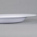 A close up of a white Carlisle melamine bowl.