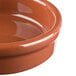 A close up of a Libbey terracotta cazuela bowl filled with liquid.