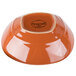An orange terracotta bowl with a logo on it.