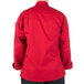 The back of a person wearing a red Mercer Culinary Millennia cook jacket.