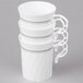 A white container with three WNA Comet white plastic coffee mugs with silver accents.