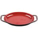 A red Libbey Coos Bay stoneware oval baker with handles.