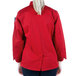 The back of a woman wearing a red Mercer Culinary Millennia long sleeve cook jacket.