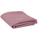 A folded pink Intedge round table cover.