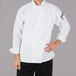 A man wearing a Mercer Culinary white long sleeve chef jacket.