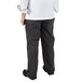 A person wearing Mercer Culinary black chalk stripe chef pants.