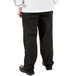 A person wearing Mercer Culinary Millennia black chef pants.